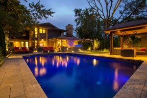 Well-lit pool and yard
